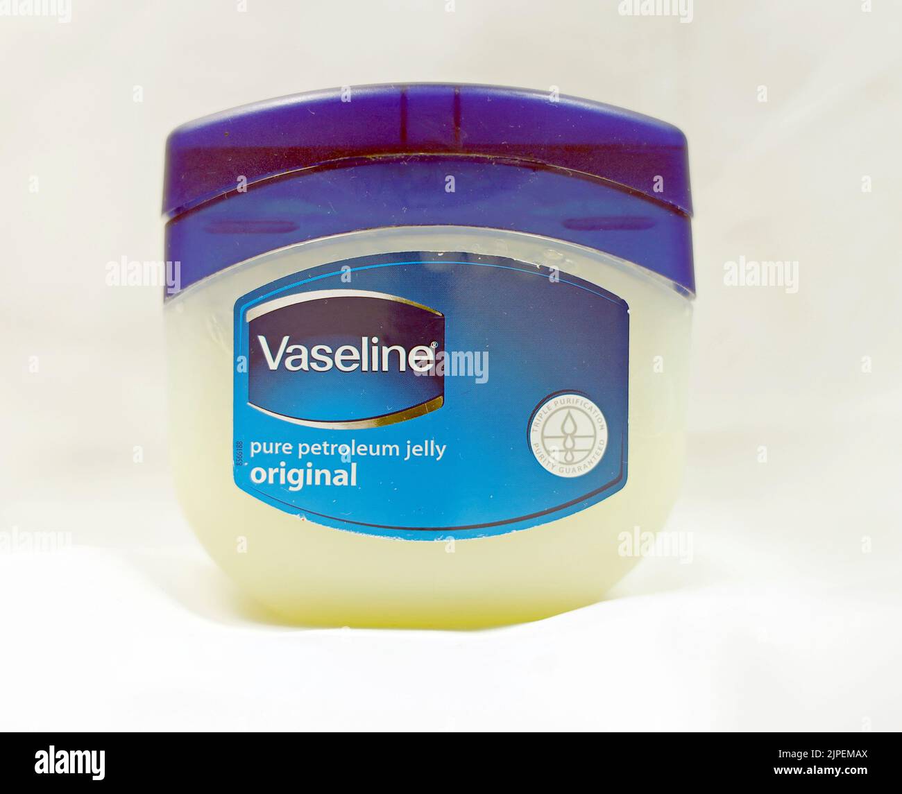 Vaseline petroleum jelly. Plastic tub / container with blue lid against white/grey background Stock Photo