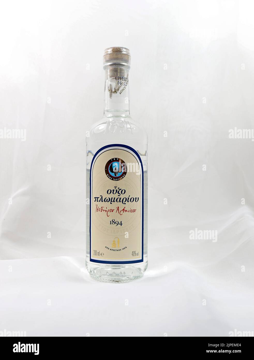 Small Greek ouzo bottle with Greek writing. 2021. Sealed with cork. Stock Photo
