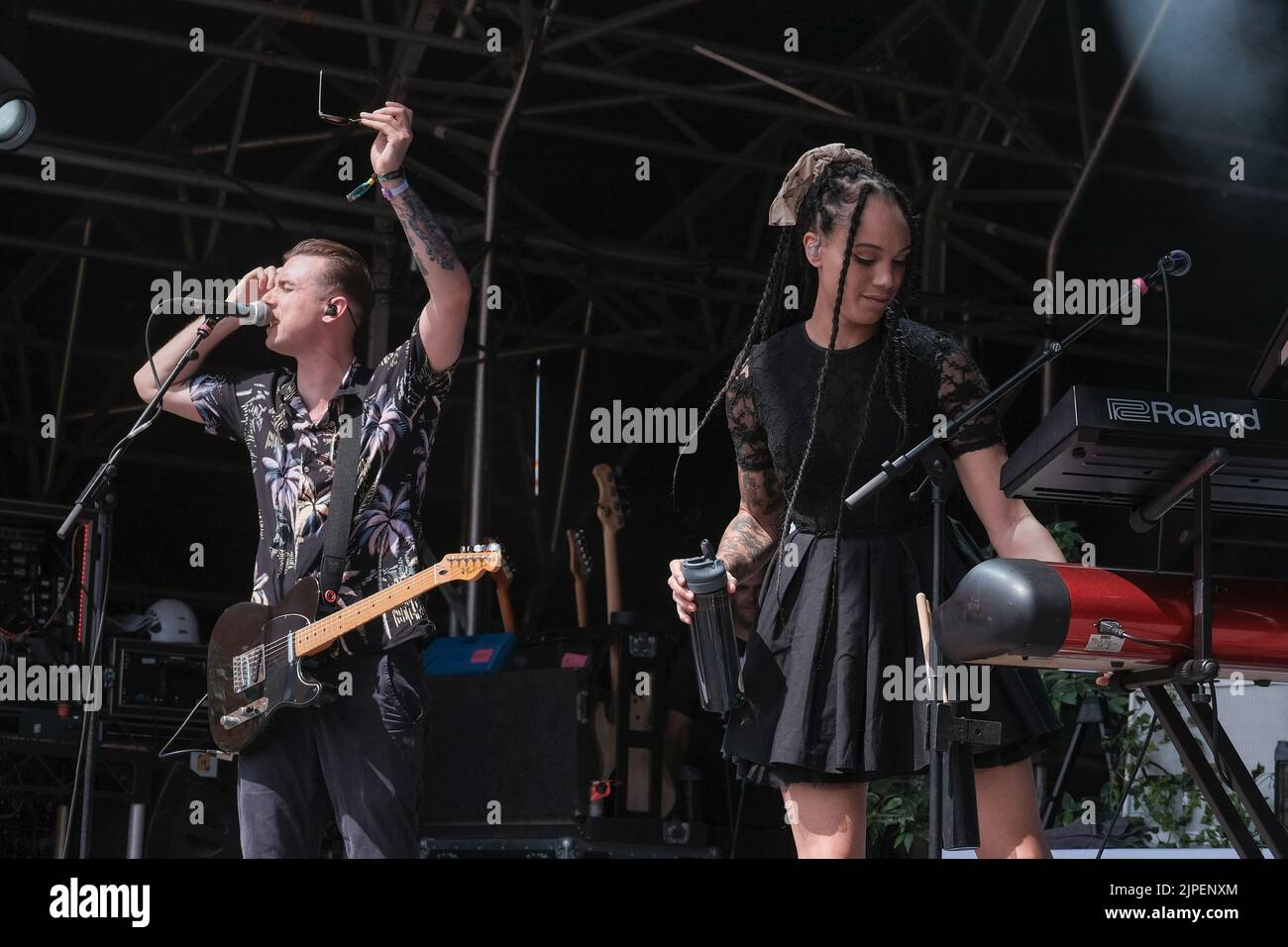 (From L-R) Joshua Waters Rudge, vocalist and guitarist and Marcia Richards, female vocalist, alto saxophone and melodica player perform with British reggae punk band The Skints live on the Grand Central stage during the Fair Festival. Boomtown is a British music festival held every year on the Matterley Estate in South Downs National Park, near Winchester. (Photo by Dawn Fletcher-Park / SOPA Images/Sipa USA) Stock Photo