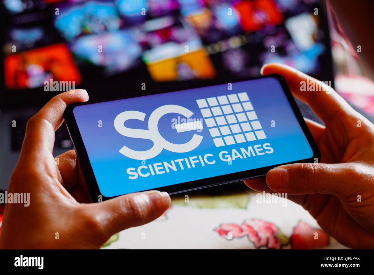 In this photo illustration, the Scientific Games Corporation logo is displayed on a smartphone screen. Stock Photo