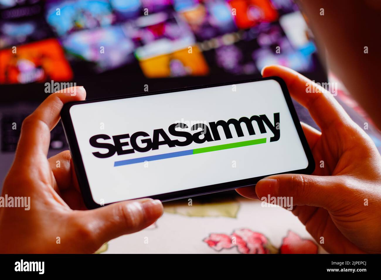In this photo illustration, the Sega Sammy Holdings logo is displayed on a smartphone screen. Stock Photo