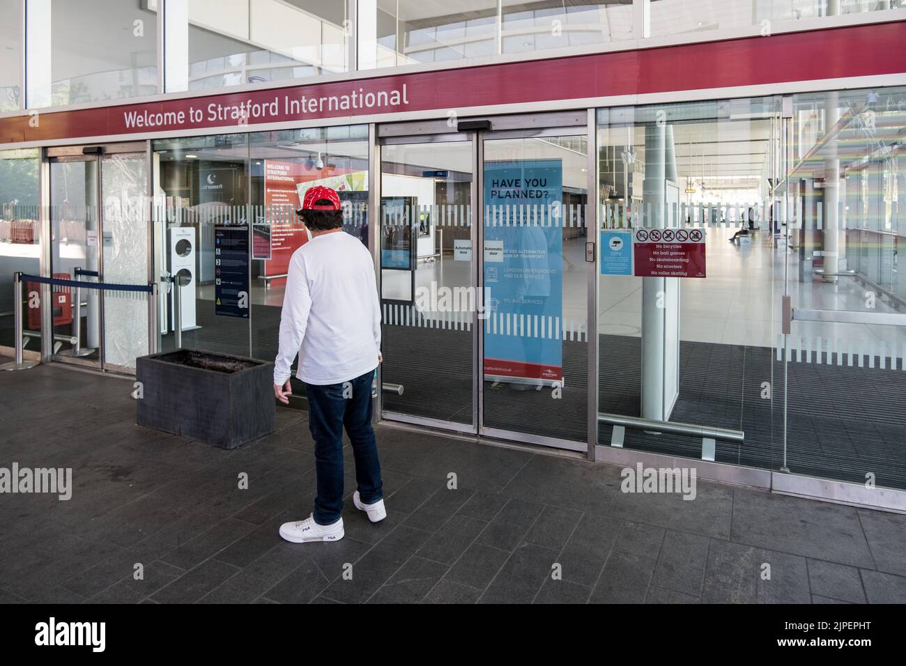 Customer stands outside Stratford International unable to enter during London Rail Strikes, Summer 2022. Stock Photo
