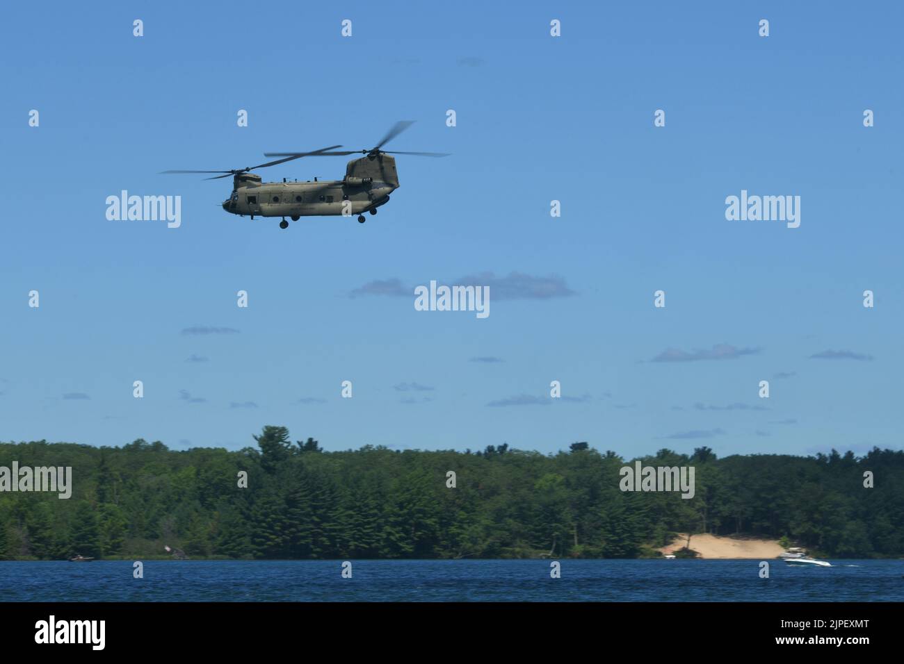 A CH-47 Chinook, 111th General Support Aviation Battalion, Florida Army National Guard, flies over Lake Margrethe during Northern Strike 22-2, at Camp Grayling, Mich., Aug. 11, 2022. Units visiting Northern Strike regularly use Lake Margrethe to conduct littoral operations (U.S. Air National Guard Photo by Staff Sgt. Tristan D. Viglianco) Stock Photo