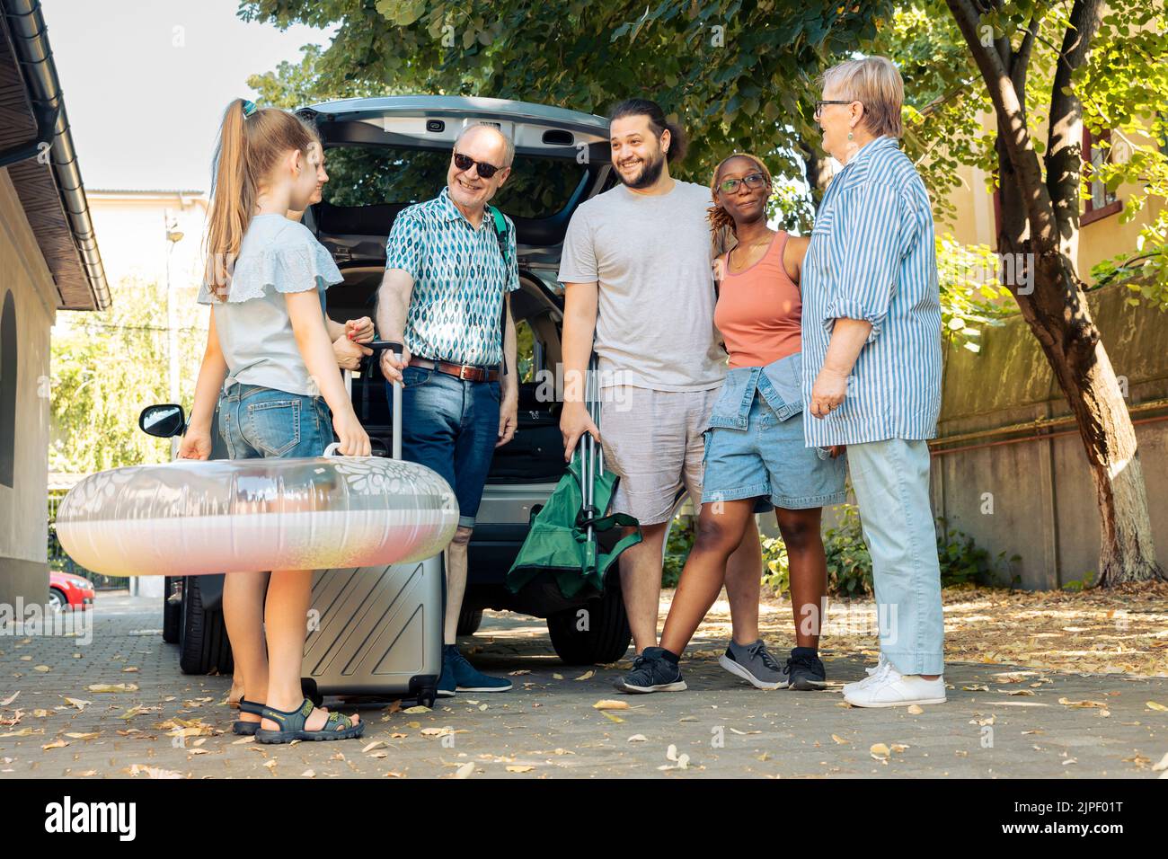 Mixed family and friends going on vacation at seaside, travelling by