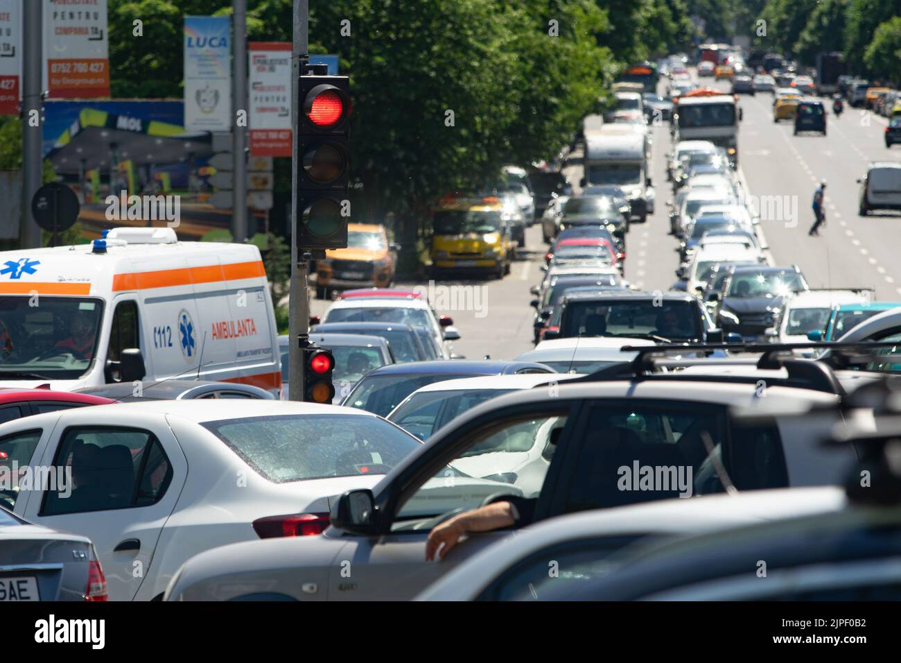 Bucharest, Romania - May 20, 2022: Cars stuck in traffic at red light at rush hour on a boulevard in Bucharest. Stock Photo
