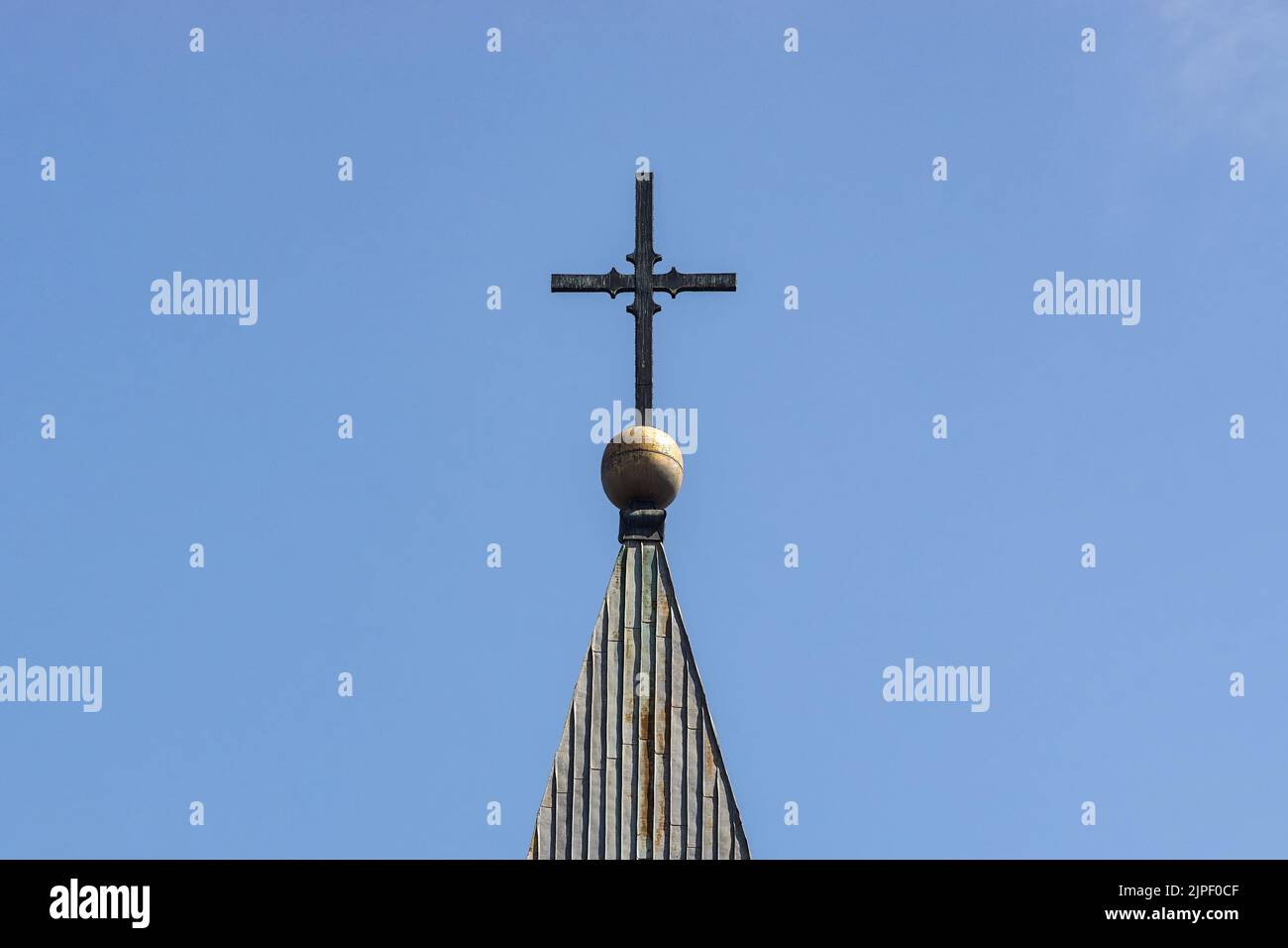 Bucharest, Romania - April 14, 2022: The cross on the bell tower of the Roman Catholic church 'Baratia', in downtown Bucharest. Stock Photo