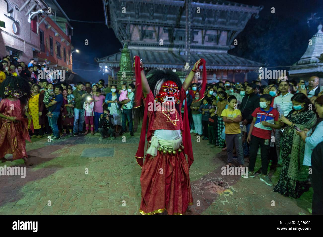 A lakhey performs a ritual dance during the celebration of the Bagh Bhairab festival. On the occasion of the Bagh Bhairab festival, devotees circumambulate Bagh Bhairab Temple for 108 times for blessings with success and good health. Stock Photo