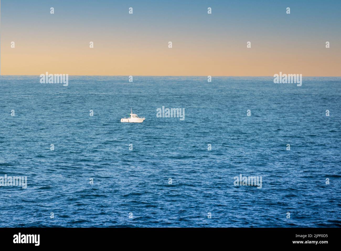 small boat in the middle of the sea on a sunny day as a marine Stock