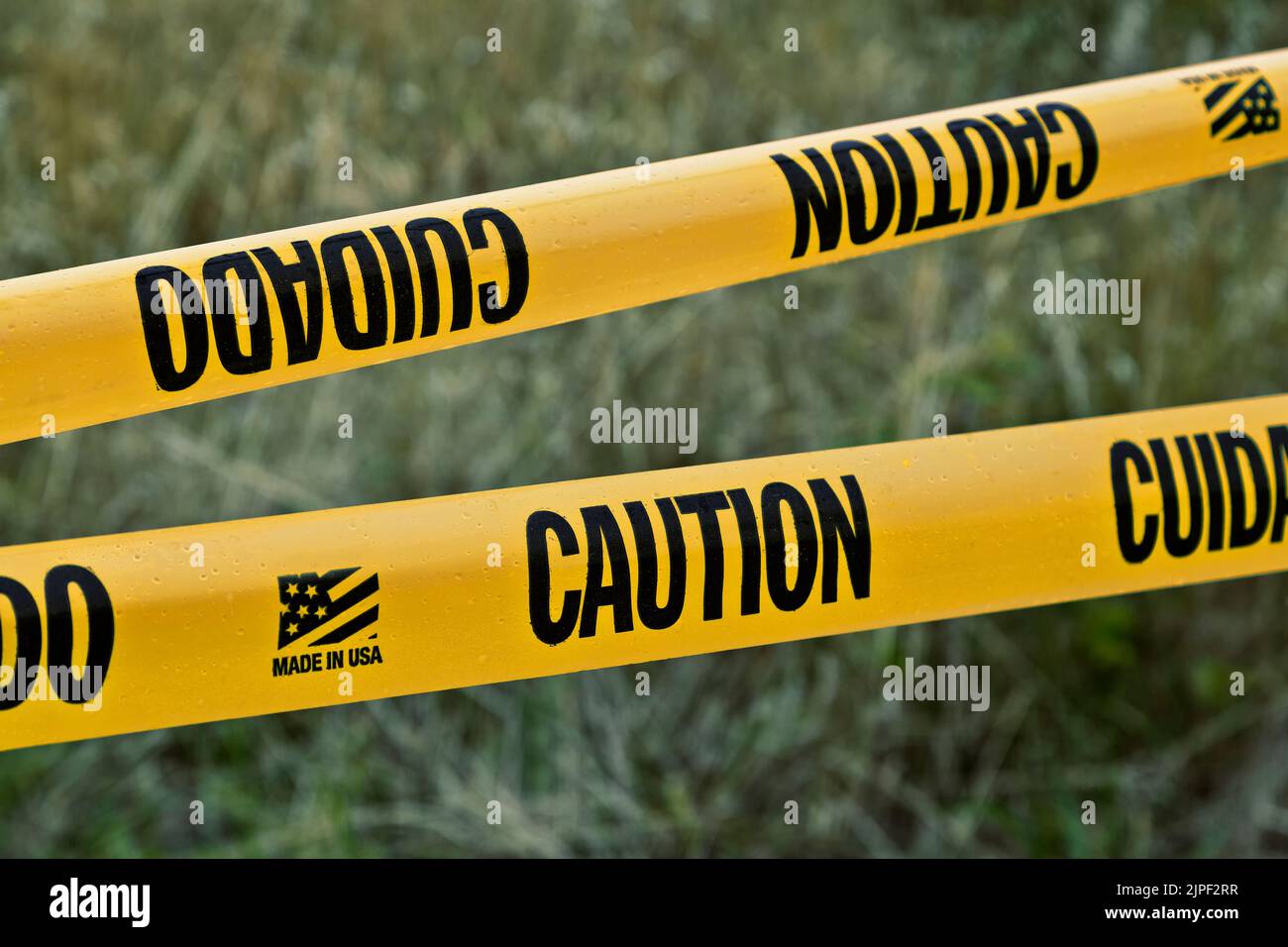 Displayed 'Caution - Cuidado'  Tape (english & spanish), restricted entry,  made in USA. Stock Photo