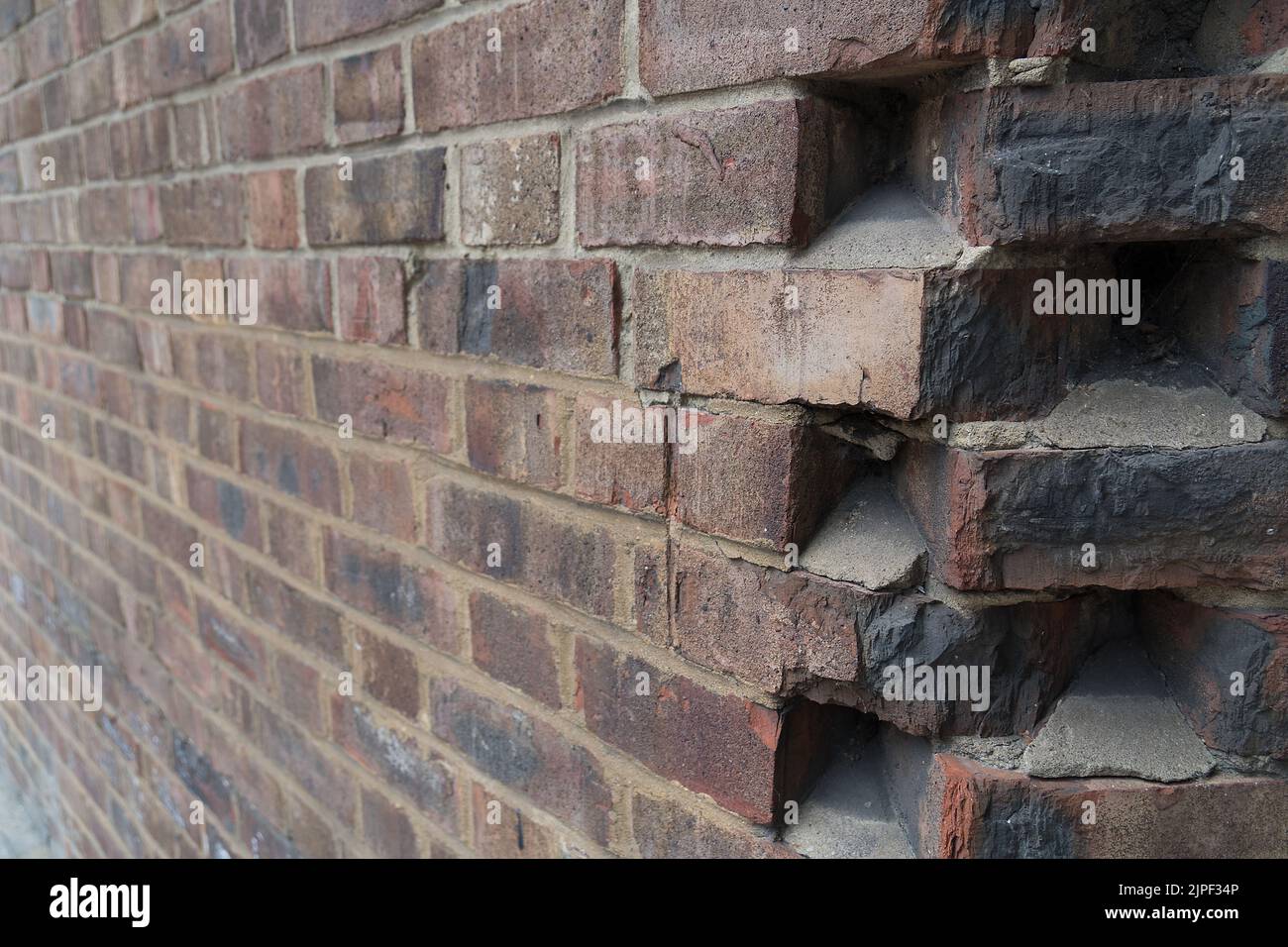 Close up of a striking corner joint of a uniformly laid brick wall with