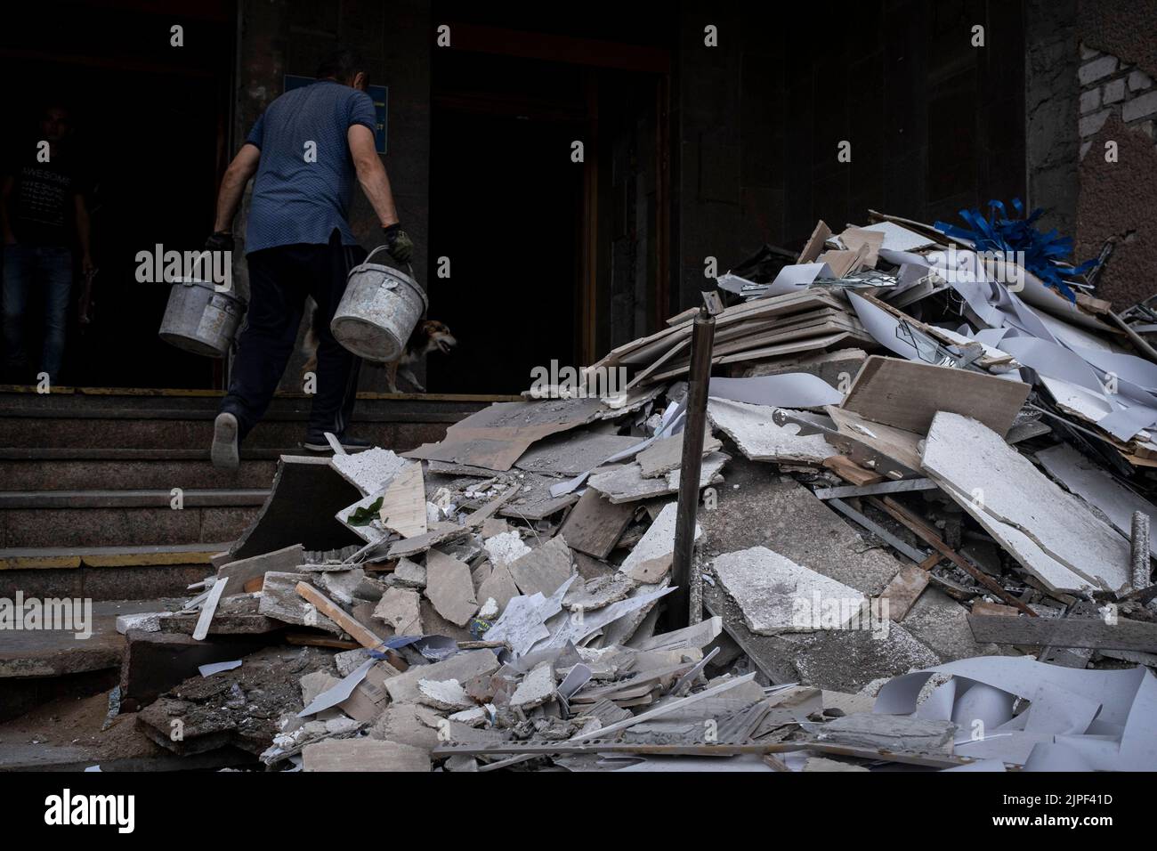 A worker removes the rubble at Petro Mohyla Black Sea National University. The university was struck by several Russian shelling at around 1:30 on August 16, as the mayor Oleksandr Sienkevych claimed no one was injured in the shelling. Russia's Ministry of Defense said earlier on social media that the university was a military strategic target with storage of heavy weapons. Stock Photo
