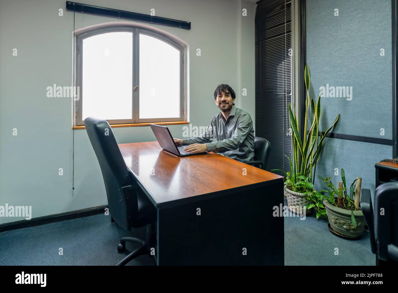 Businesswoman sitting at the head of the meeting table looking at her