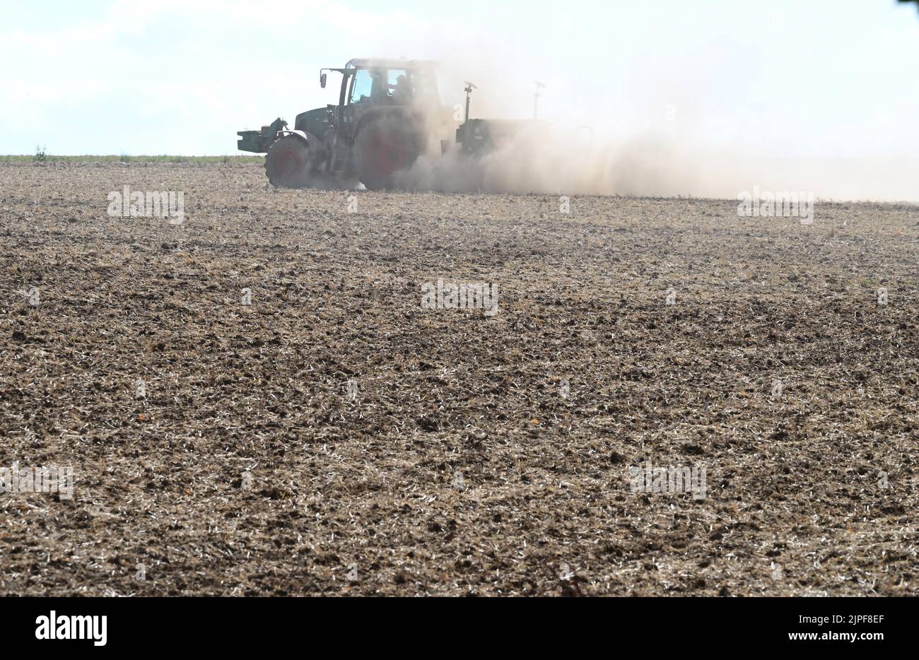 Stuttgart, Germany. 16th Aug, 2022. A tractor drives over a harvested ...