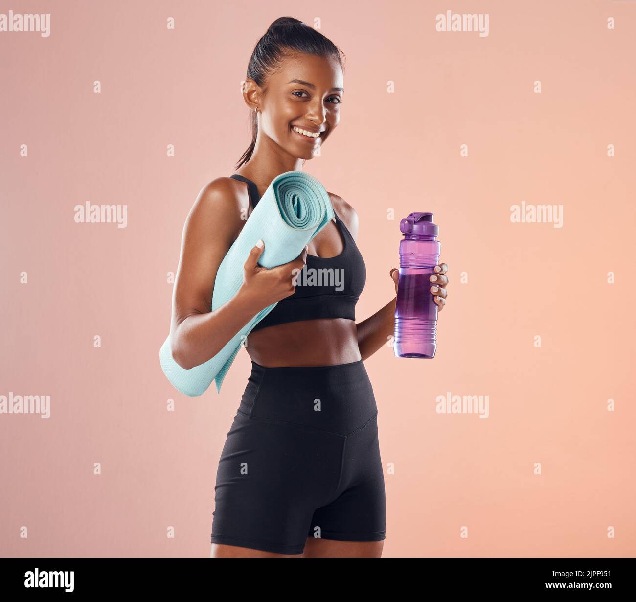 Active woman getting ready for routine fitness workout, holding yoga ...