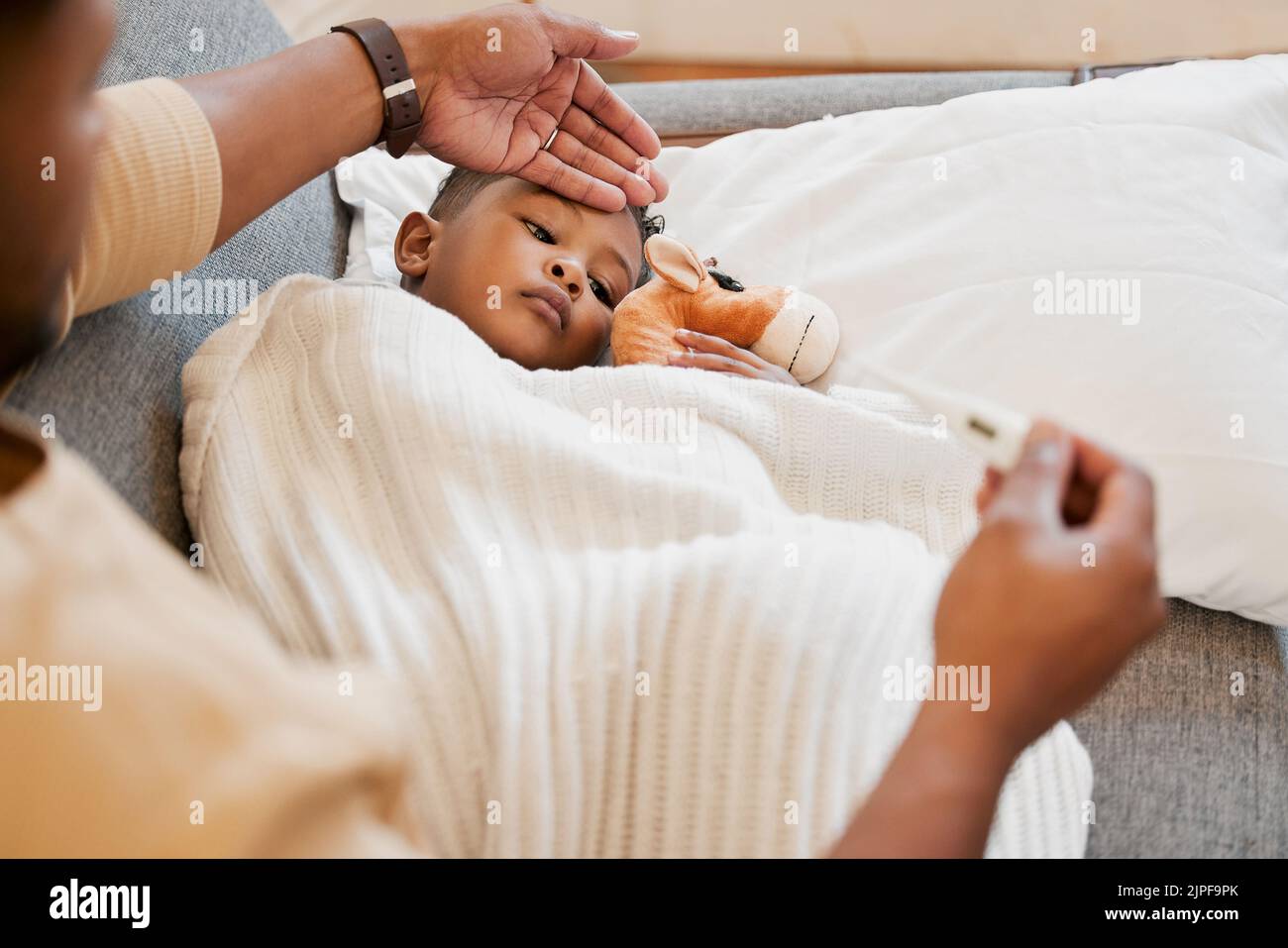 Sick, flu and cold child in bed, sad and ill with allergy and unwell at home with his worried