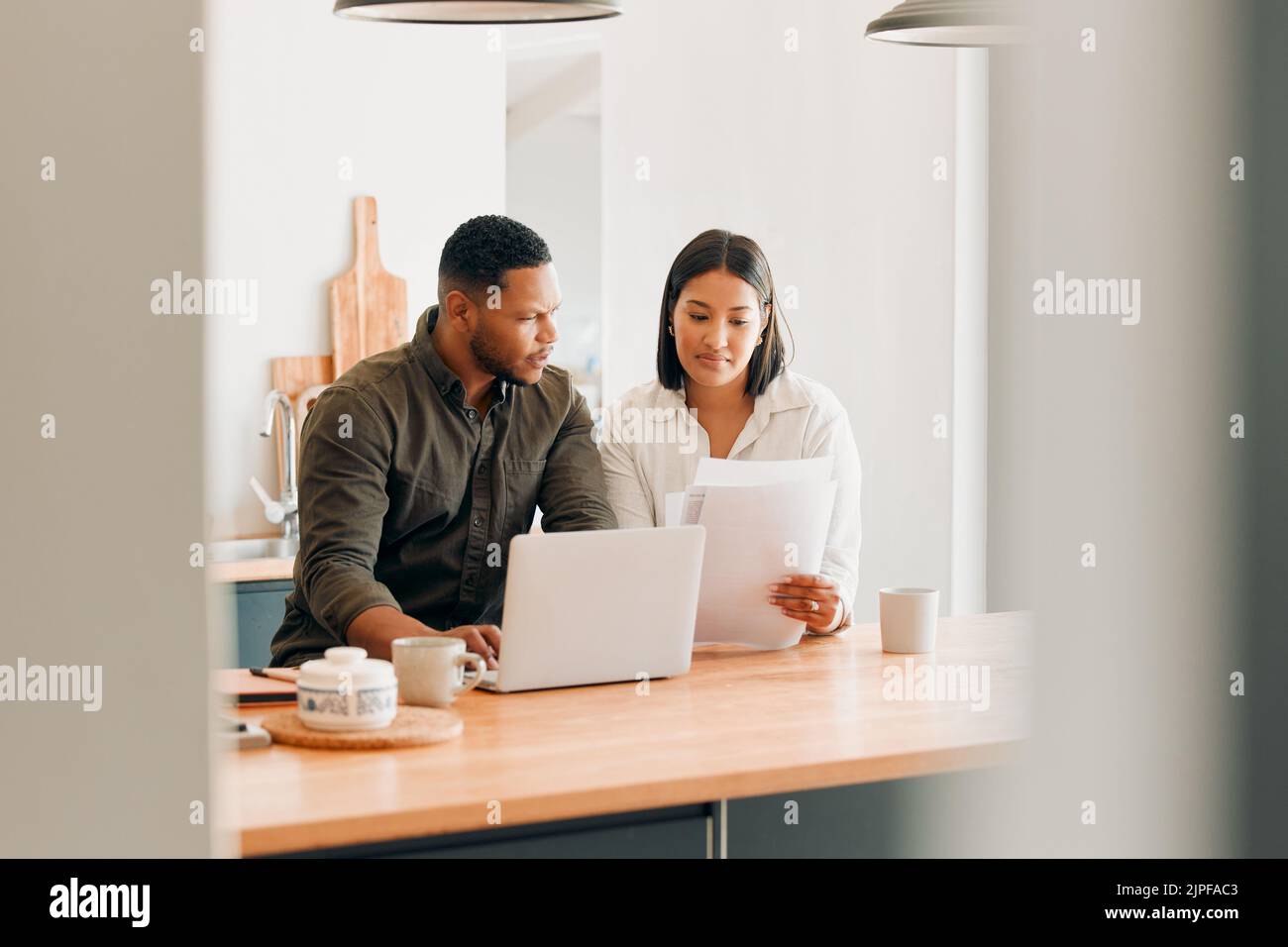 Planning home loan couple with laptop looking at budget, bills or finance paper work confused by the expenses, budget or mortgage. Married man and Stock Photo