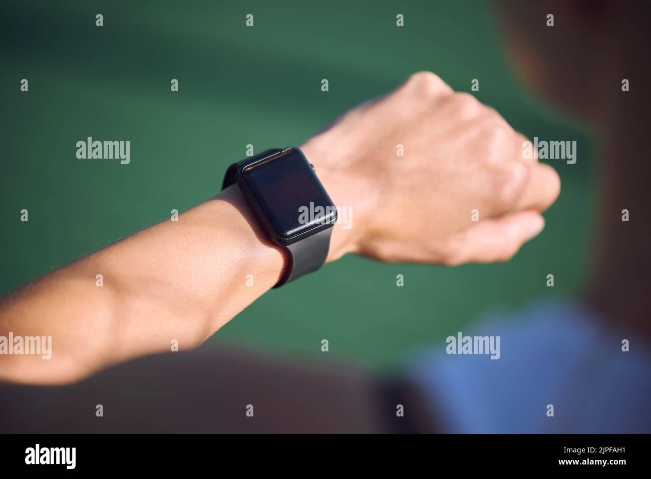 Athlete checking watch time, heart rate and step count during run