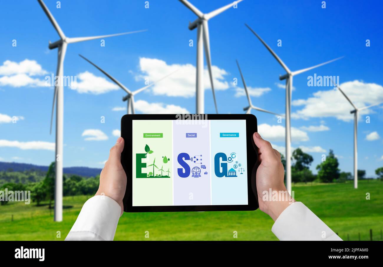 Green business transformation for environment saving and ESG business concept. Businessman using tablet to set corporate goal toward environmental Stock Photo