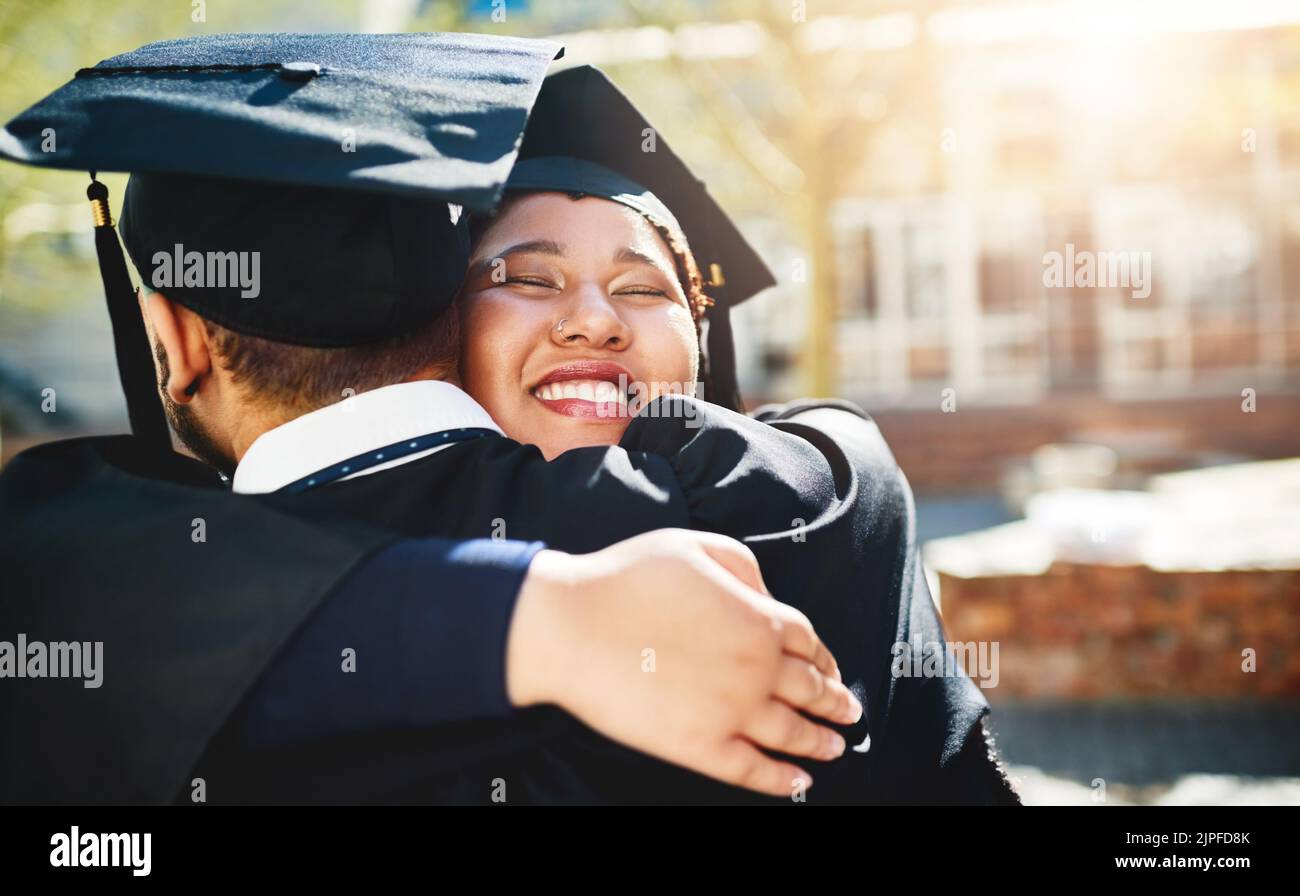 We worked so hard to get here. a young woman embracing her male friend after graduating. Stock Photo