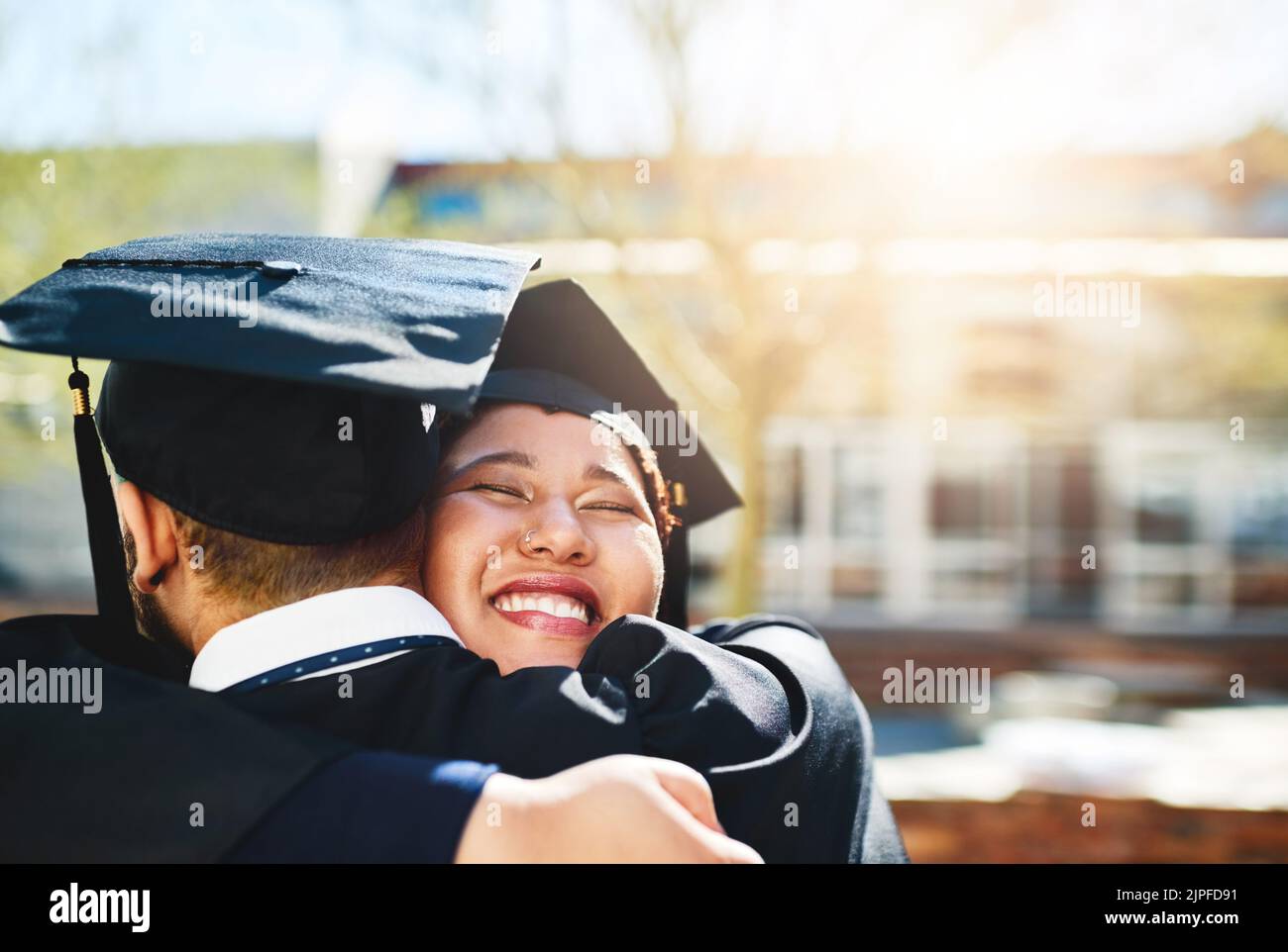 Im so glad you made it. a young woman embracing her male friend after graduating. Stock Photo