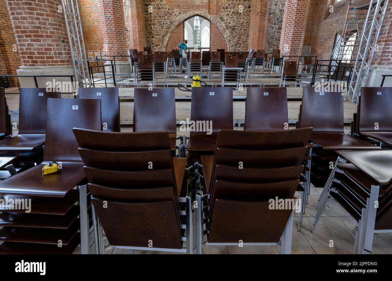 10 August 2022, Saxony-Anhalt, Dessau-Roßlau: Chairs are placed in St. Mary's Church in Dessau. Inside the church, which has long since ceased to be used as a church but as an event space, work is in full swing on the new theater for actor and cabaret artist Dieter Hallervorden. The theater will start its first season as planned on September 4. The play 'God's Life Course' will have its premiere. The program of the venue, called 'Mitteldeutsches Theater in der Marienkirche,' promises a mix of plays, comedies, readings and concerts. Hallervorden was born in the Bauhaus city. Photo: Hendrik Schm Stock Photo