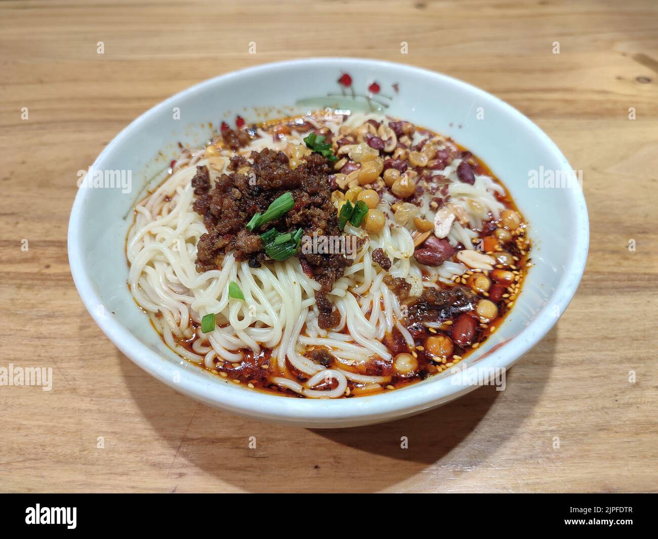 Sichuan noodles with peppery sauce in the white bowl for eating Stock Photo