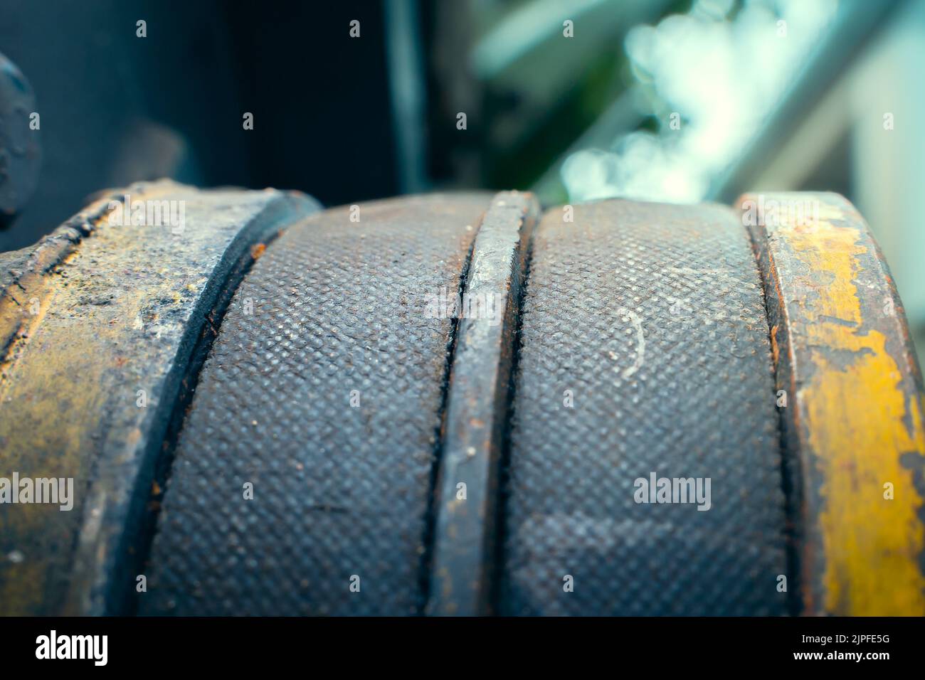 Two drive belts on a pulley closeup. Worn parts of an old walkbehind