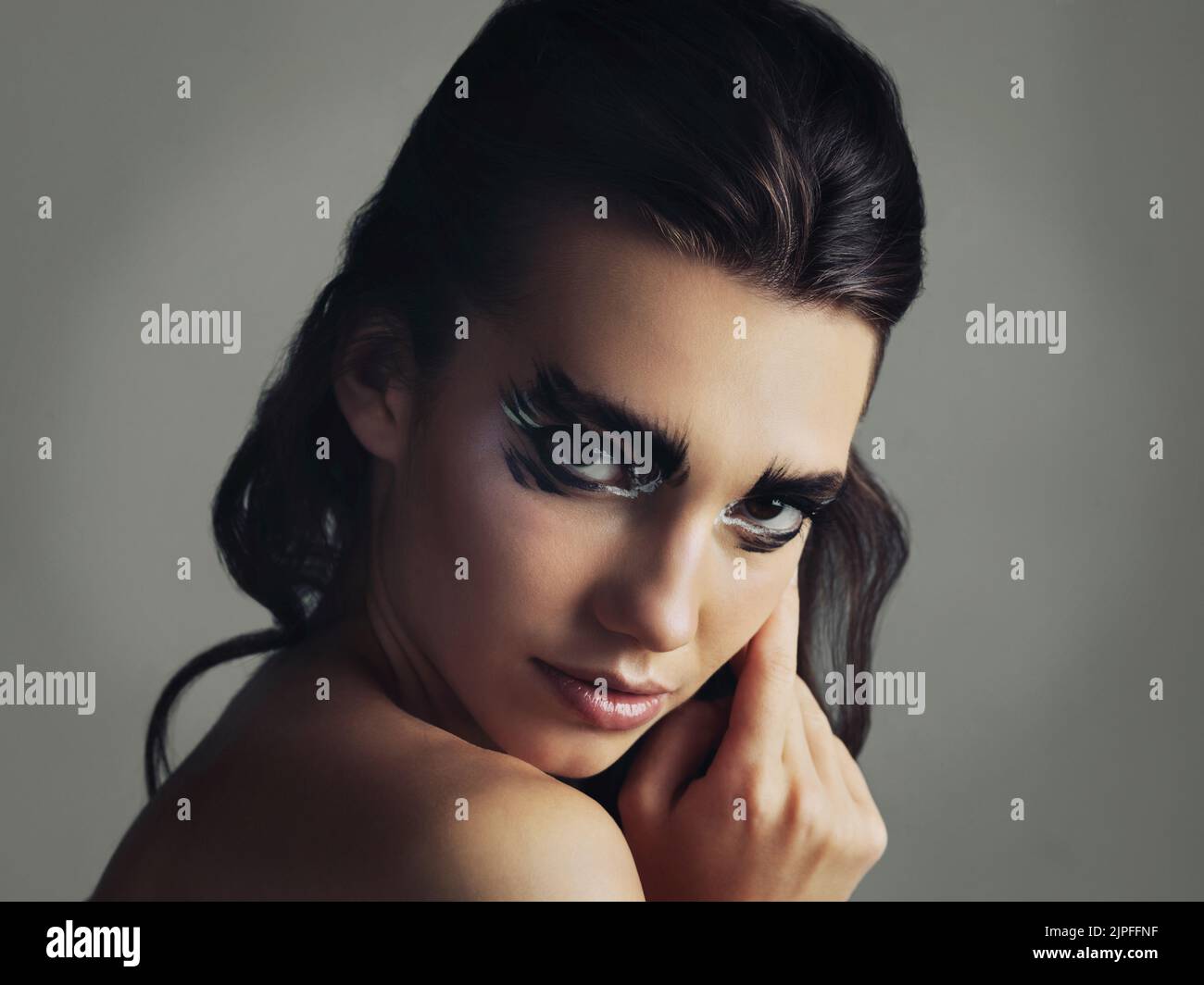 Keep calm and be different. Studio shot of an attractive young woman wearing bold eye makeup. Stock Photo