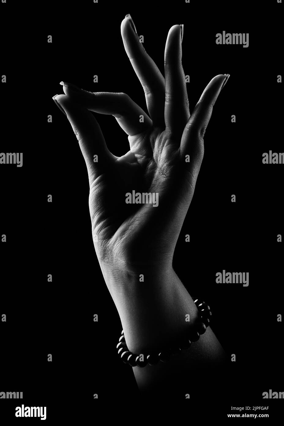 A vertical shot of a religious Christian hands sign on a black background Stock Photo Alamy