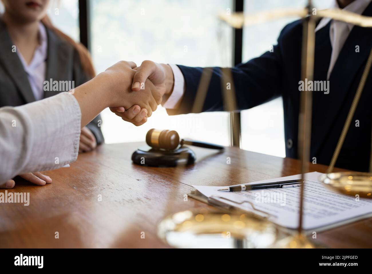 Business team and lawyer shaking hand after discussing about agreement contract. Law, legal services, advice, Justice concept Stock Photo