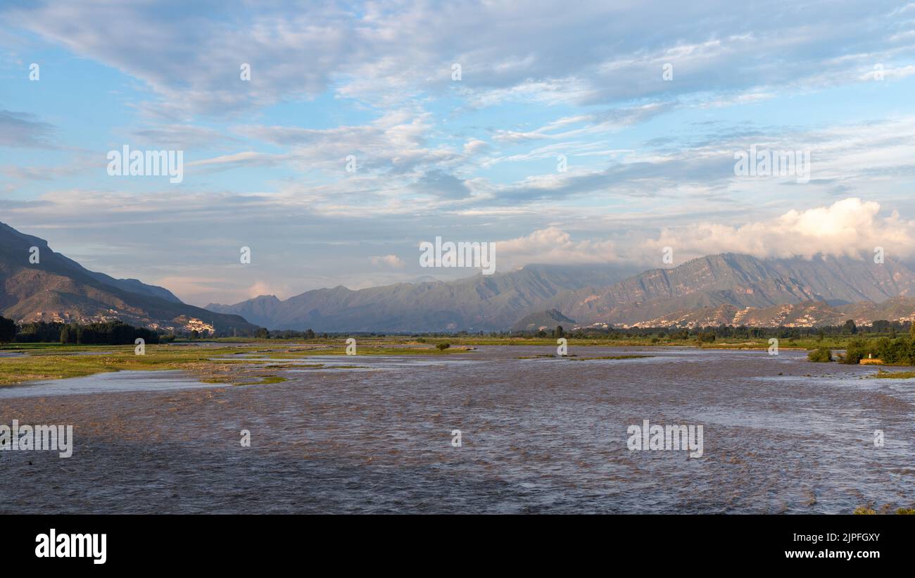 High level flood in the Swat River washed away agriculture fields Stock Photo