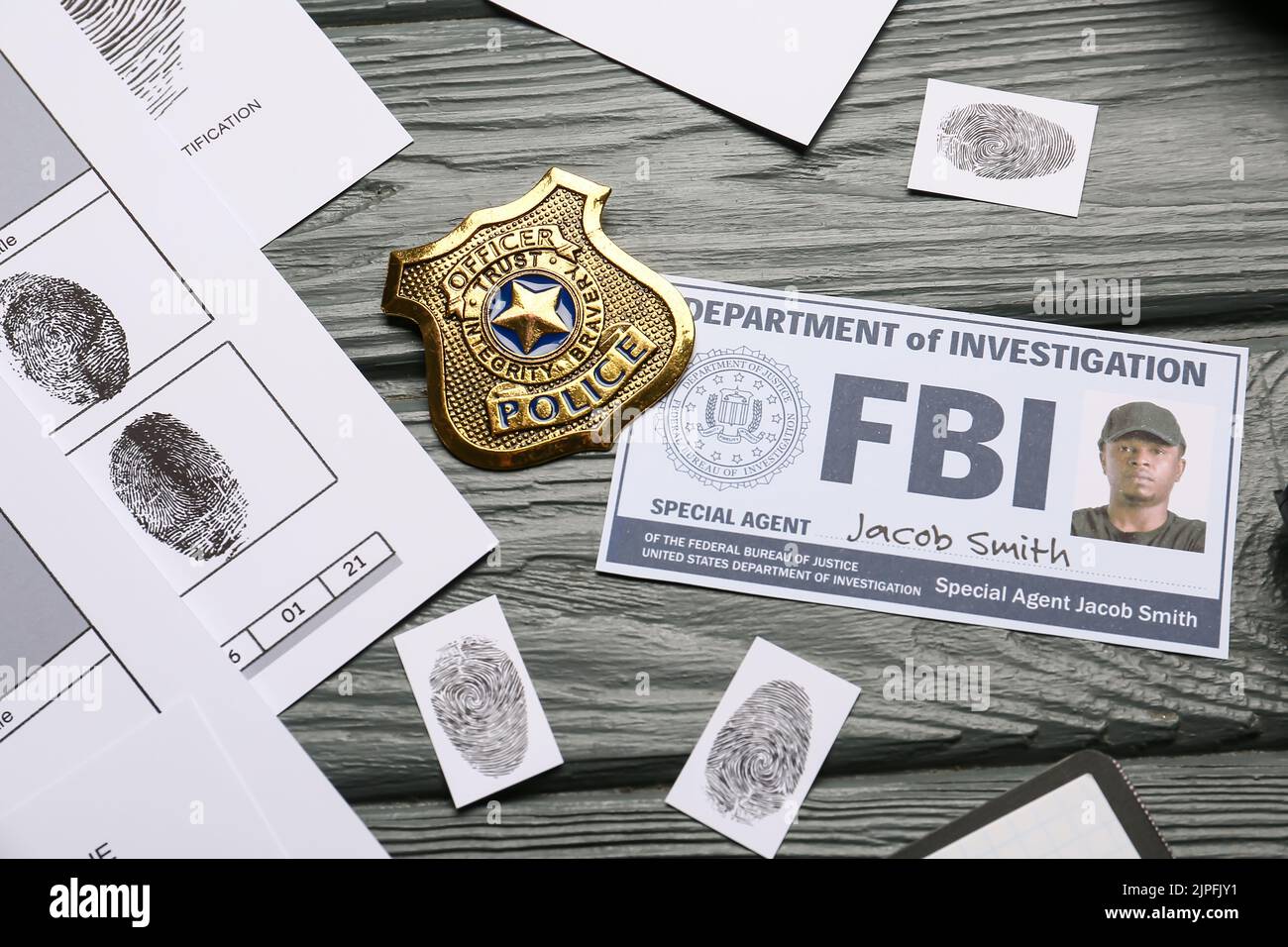 Finger prints with document of FBI agent and badge on wooden background Stock Photo