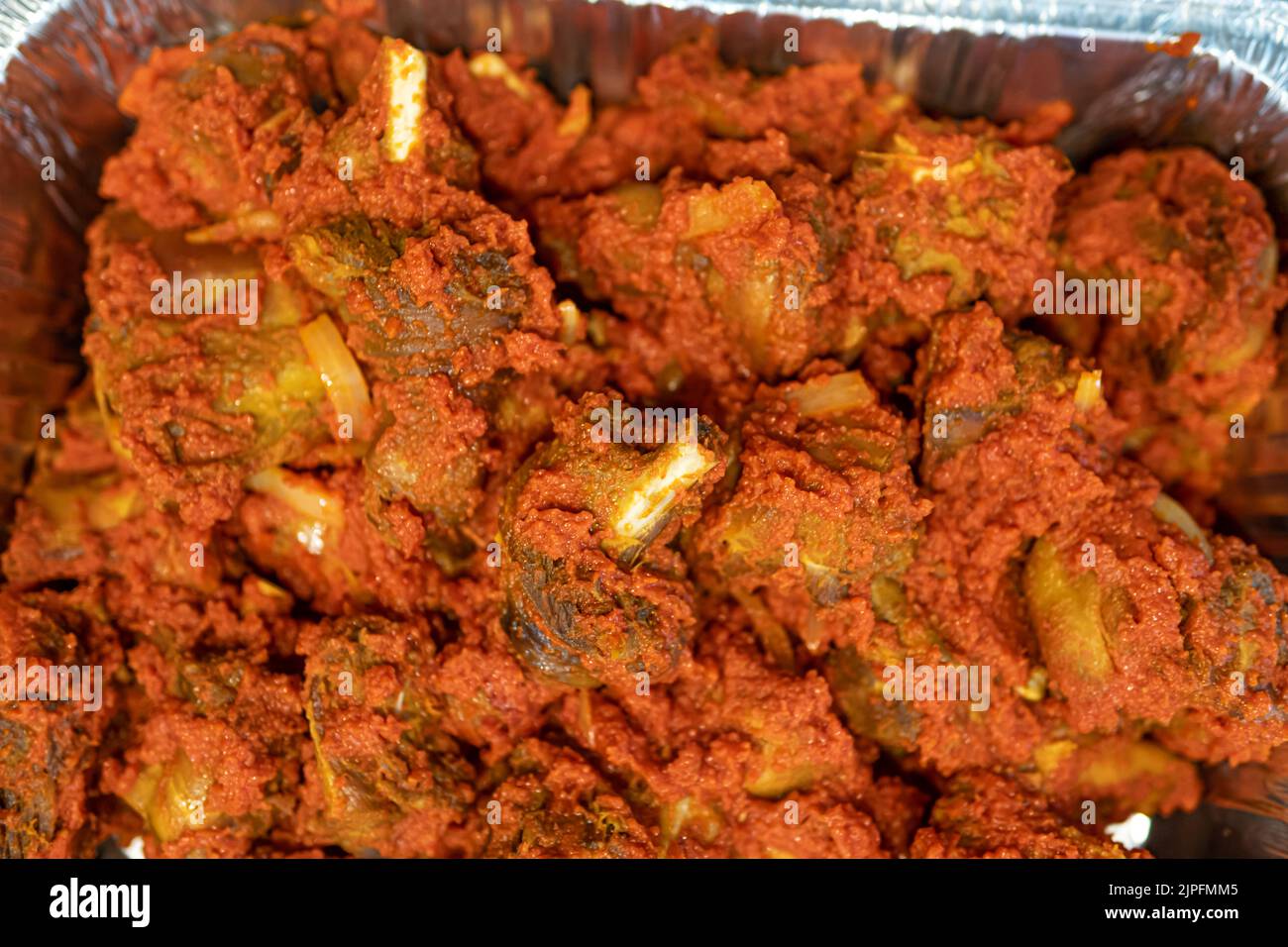 Tray of Nigerian spicy peppered chicken ready to eat Stock Photo Alamy