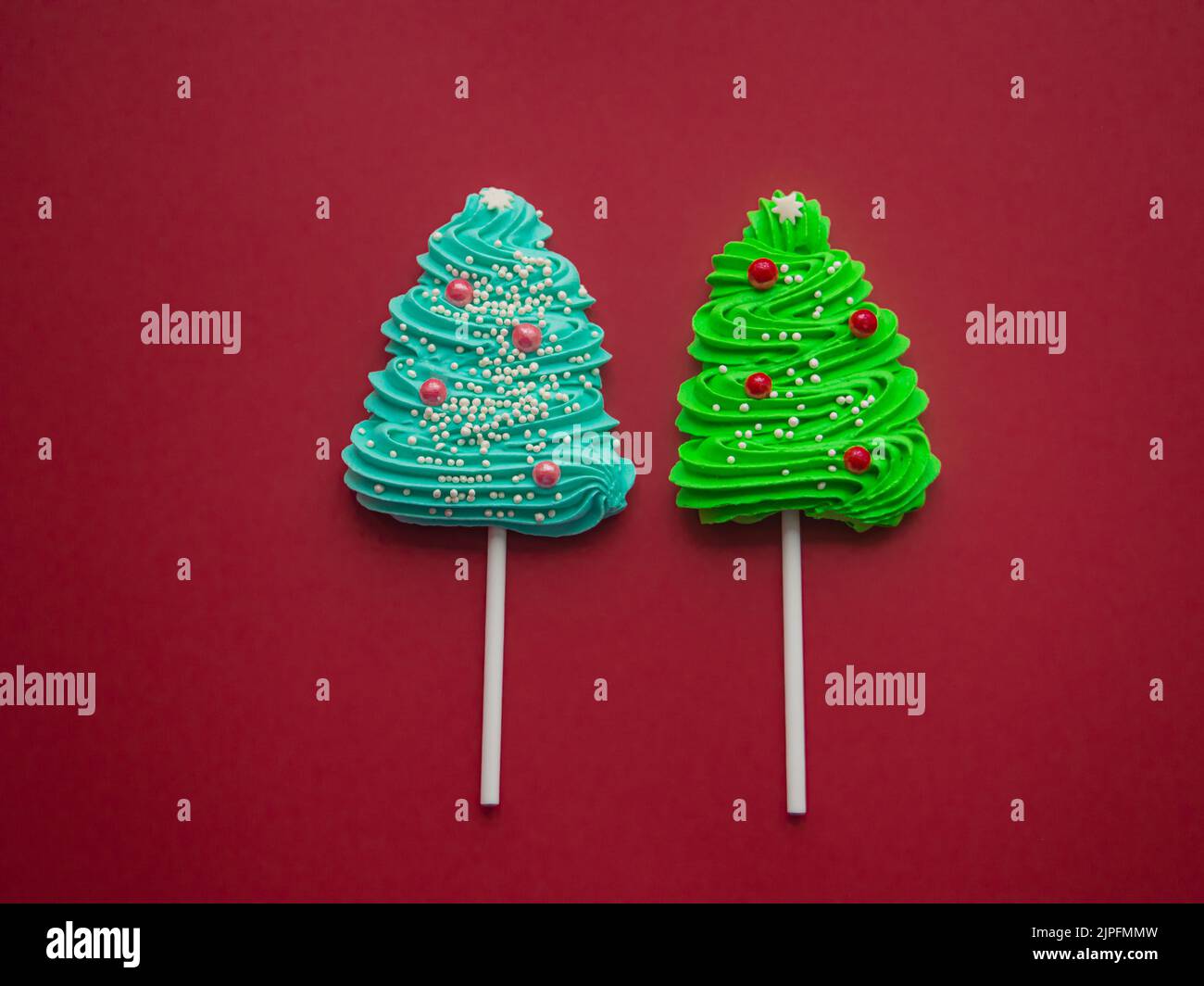 green-and-blue-candies-in-the-form-of-a-christmas-tree-on-a-red