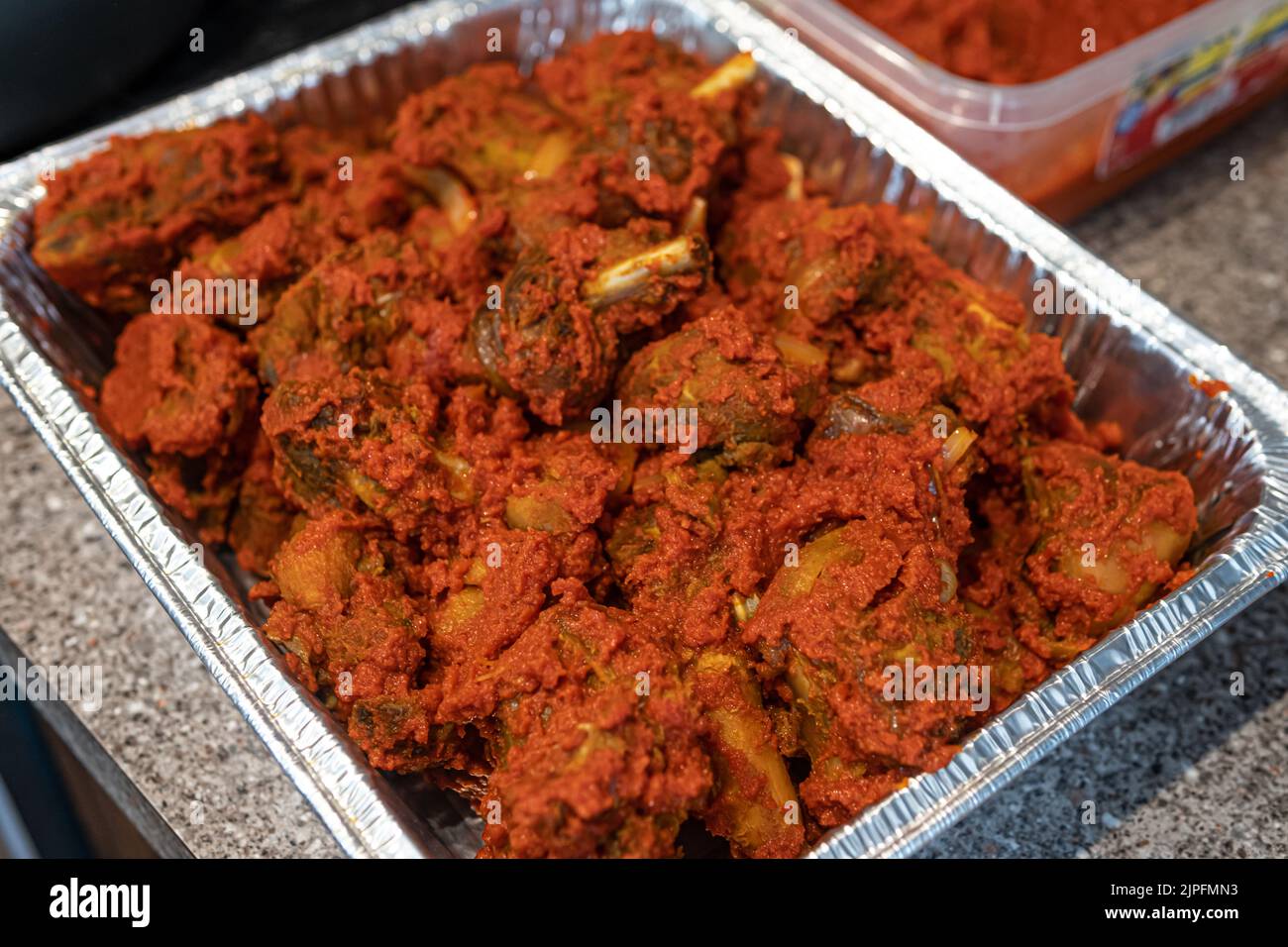 Tray of Nigerian spicy peppered chicken ready to eat Stock Photo Alamy