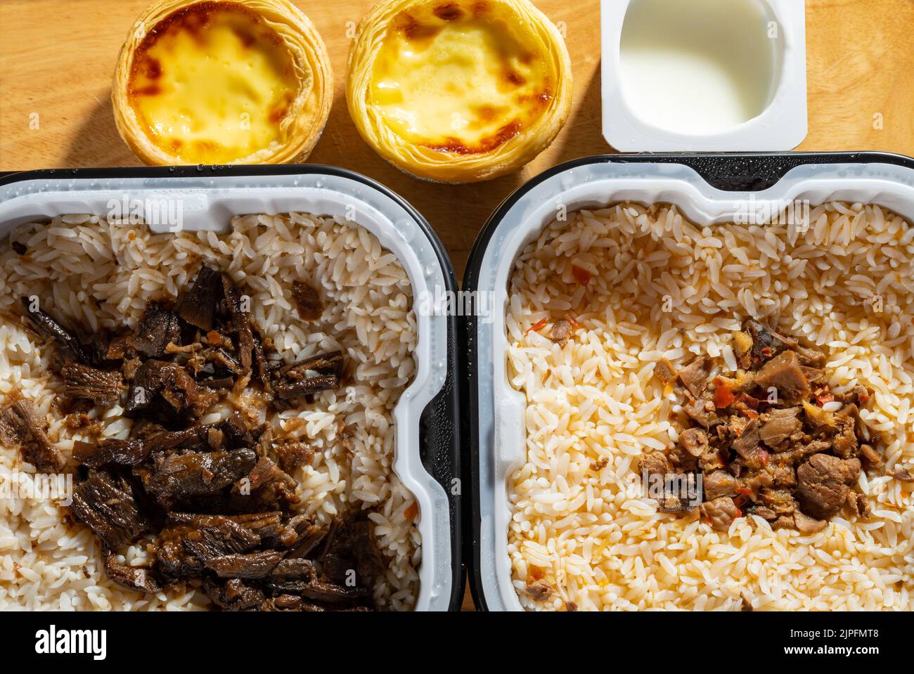 fresh self cooking fast food of rice with egg tart and yogurt Stock Photo