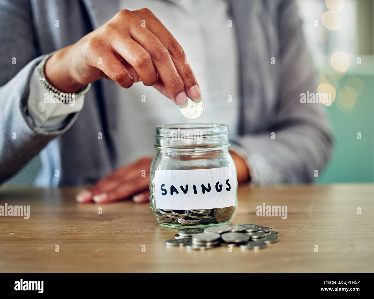 . Savings jar, money coins and change of a woman hand holding and