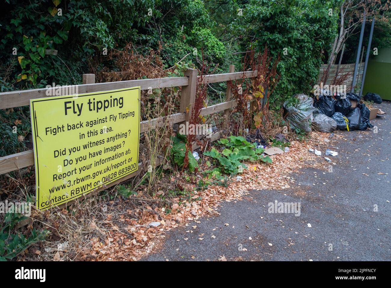 Windsor, Berkshire, UK. 17th August, 2022. A fly tipping sign in a car park outside a public park in Windsor where fly tipping continues to be an issue despite there being a council run tip in Maidenhead that residents can use for free. Credit: Maureen McLean/Alamy Stock Photo
