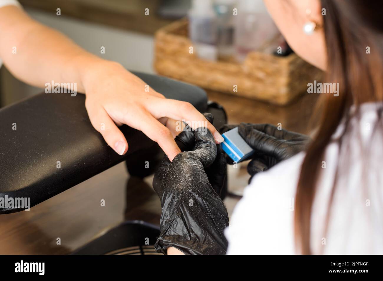 Manicurist work process. The master processes the client's nails with