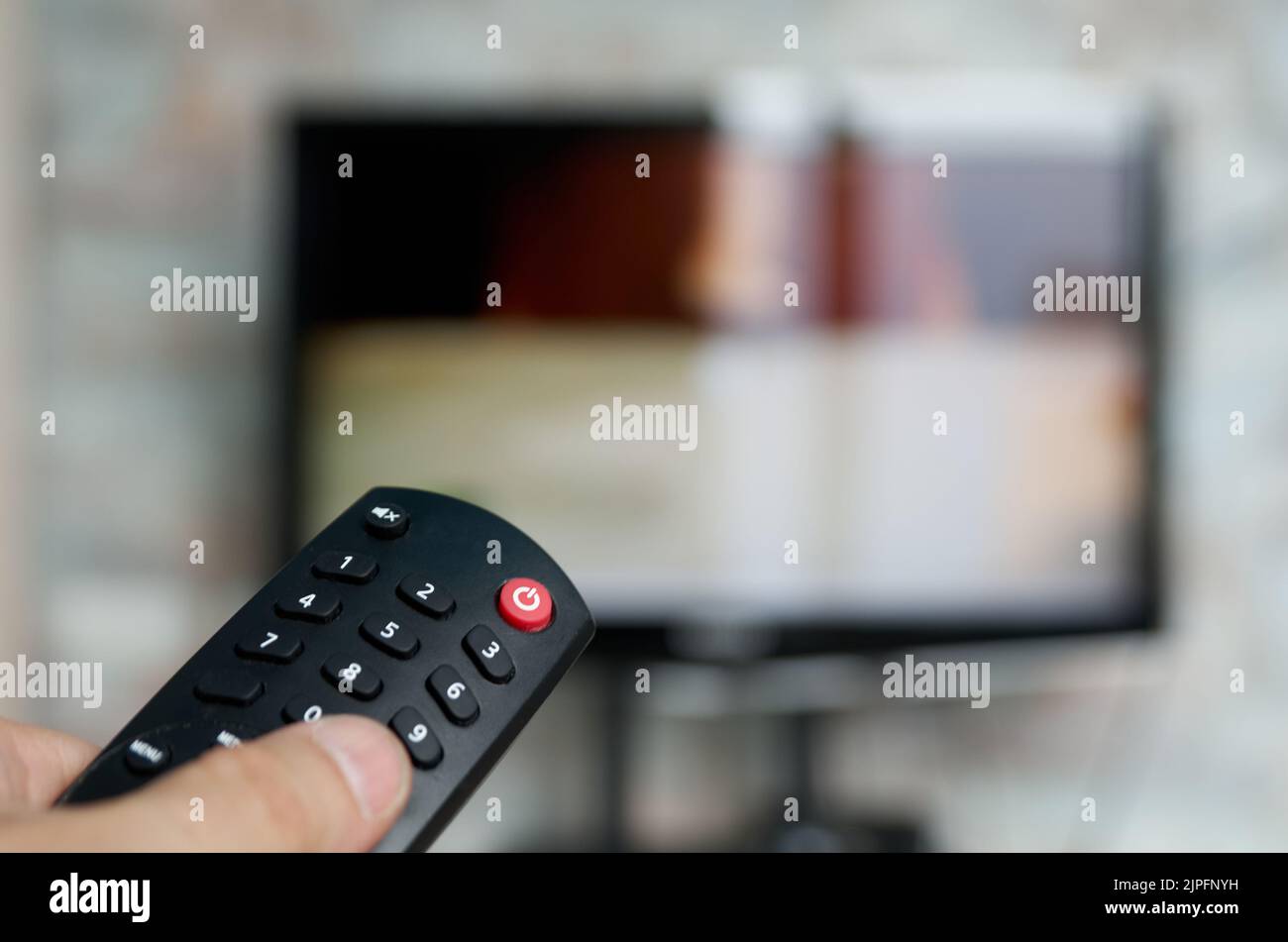 Changing TV program: close up of human hand holding television remote ...