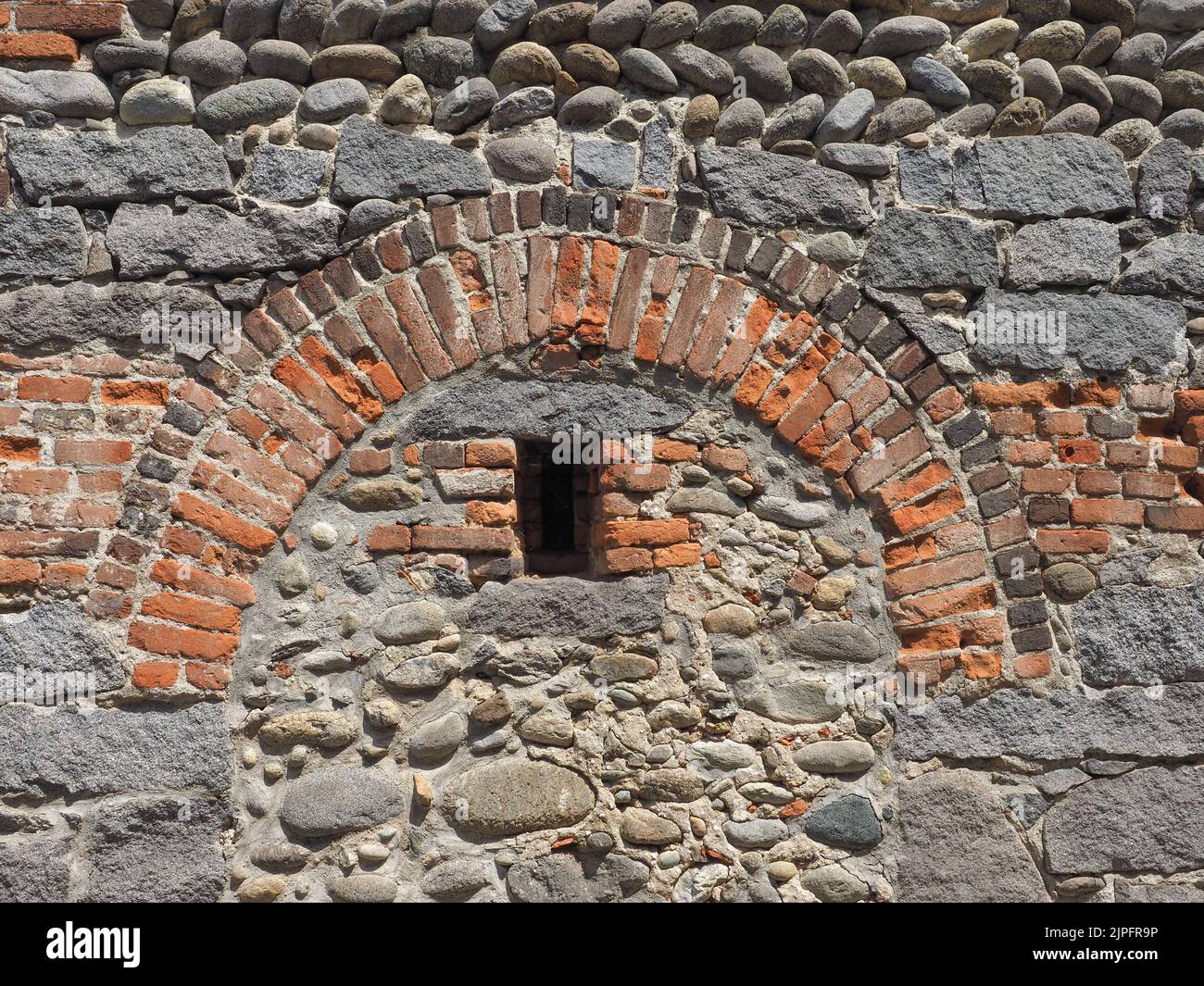 red brick arch in an old wall useful as a background Stock Photo Alamy