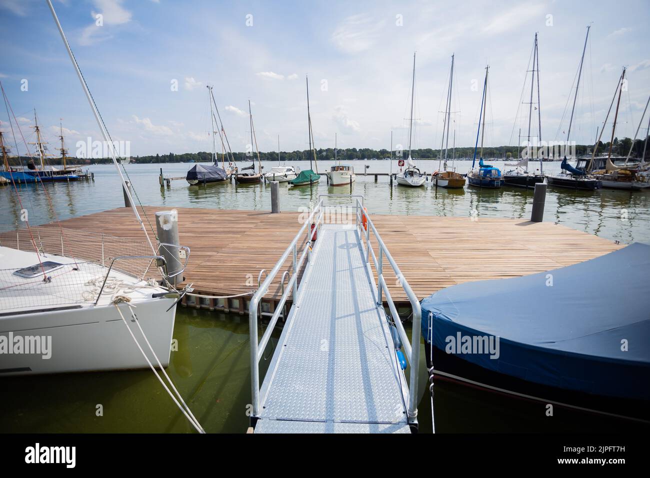 Berlin, Germany. 17th Aug, 2022. The barrier-free floating jetty platform of the association 'Seglerhaus am Wannsee', which enables sailors to board the boat more easily. After the Special Olympics World Games 2023 in Berlin, the platform, which cost 200,000 euros, is to be dismantled for just as much money because, in the view of the district authorities, it casts shadows on the water and impairs fish. Credit: Christoph Soeder/dpa/Alamy Live News Stock Photo