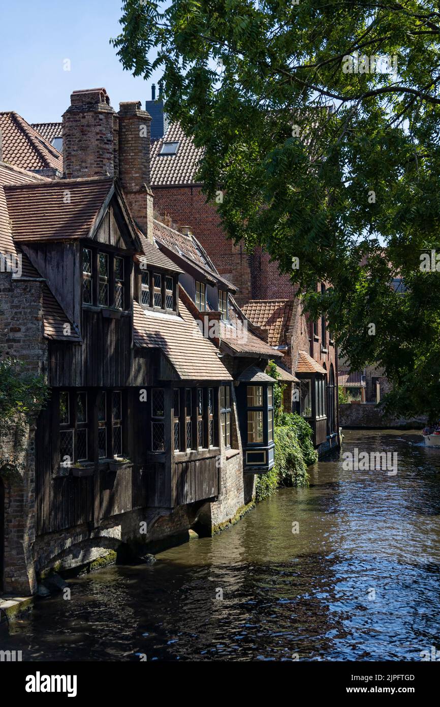BRUGES, BELGIUM - AUGUST 11, 2022:  View of the medieval canalside houses near the Bonifacius Bridge Stock Photo