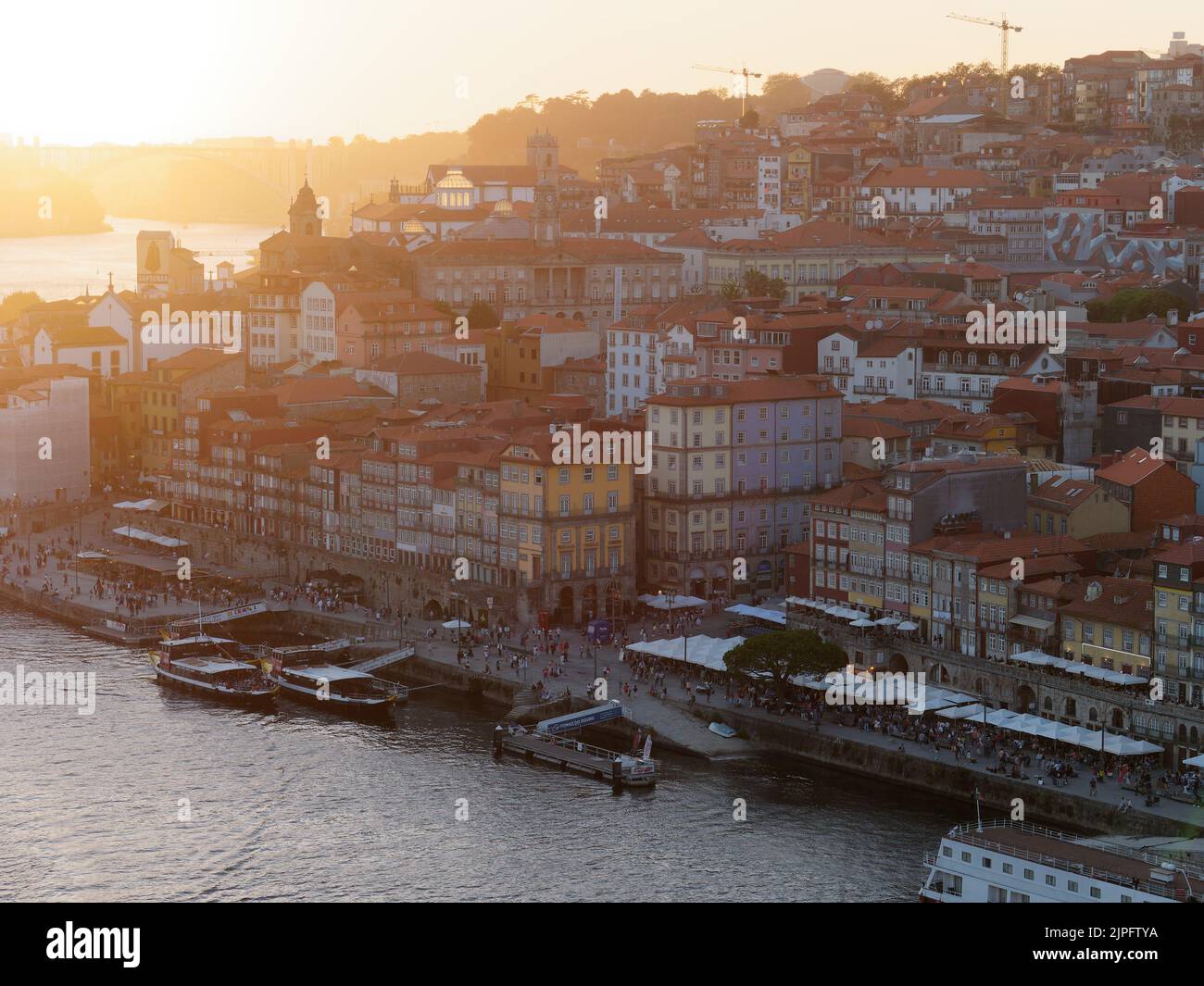Elevated view of the Ribeira riverfront district and the Douro river in Porto, Portugal. Boats are moored in the harbour. Stock Photo