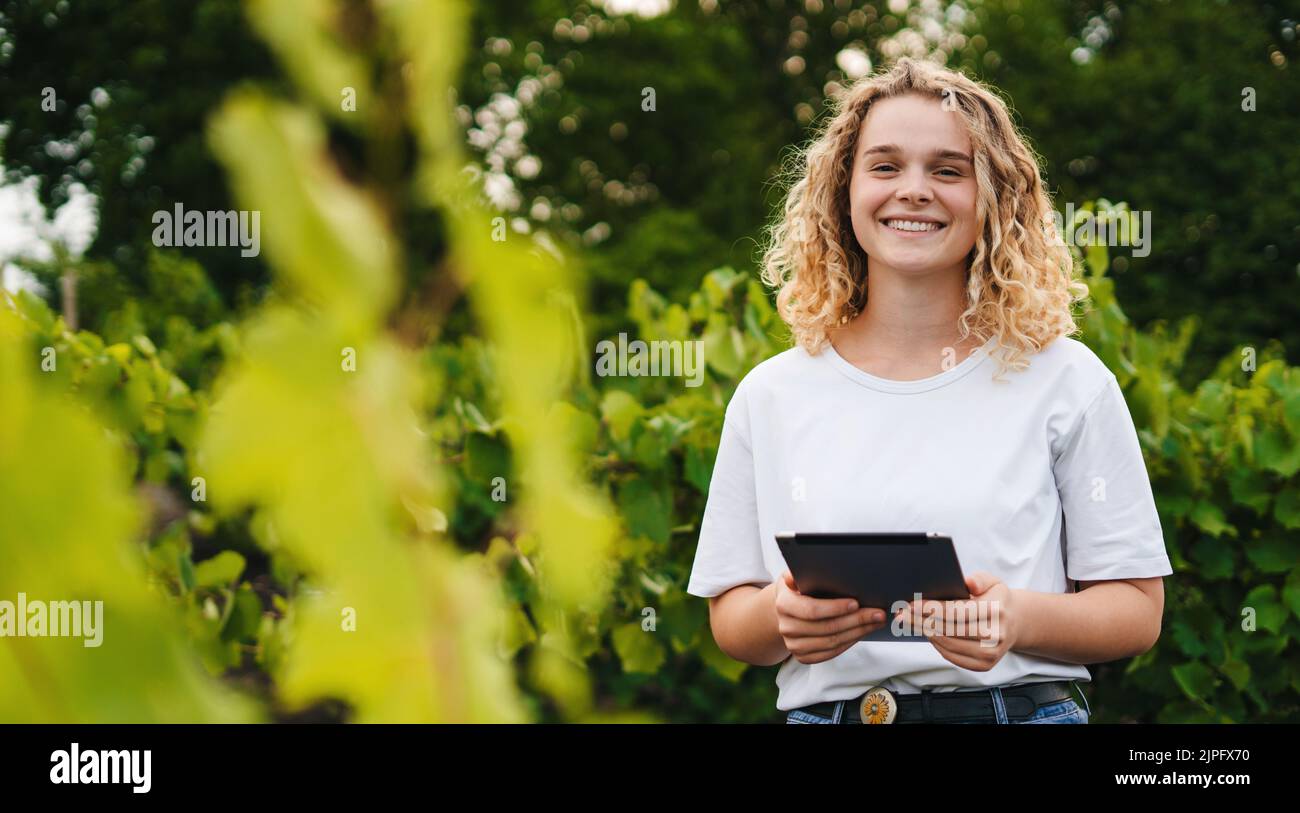 Caucasian curly farmer with tablet smiling looking at camera and ...