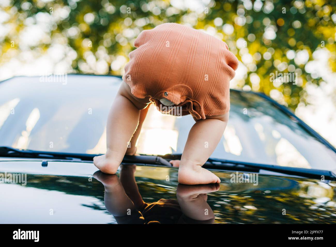 Woman sitting on car hood hi-res stock photography and images