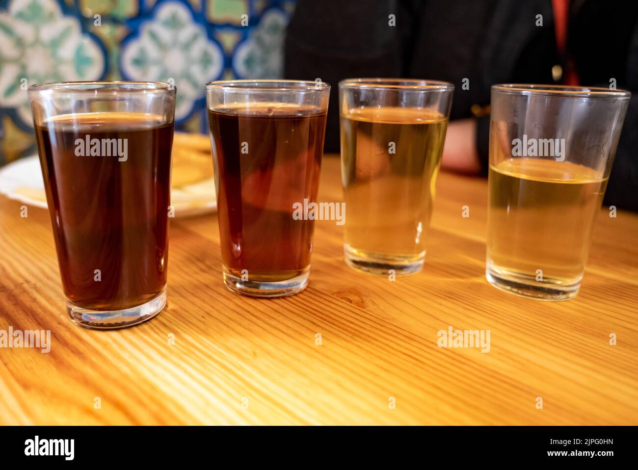 Tasting of different sweet wines from wooden barrels on old bodega wine