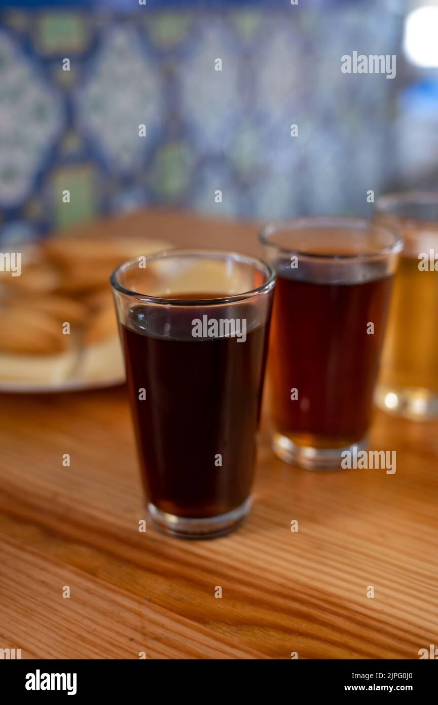 Tasting of different sweet wines from wooden barrels on old bodega wine