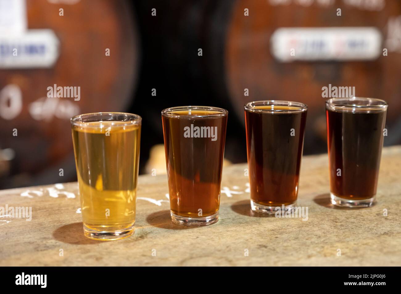 Tasting of different sweet wines from wooden barrels on old bodega wine