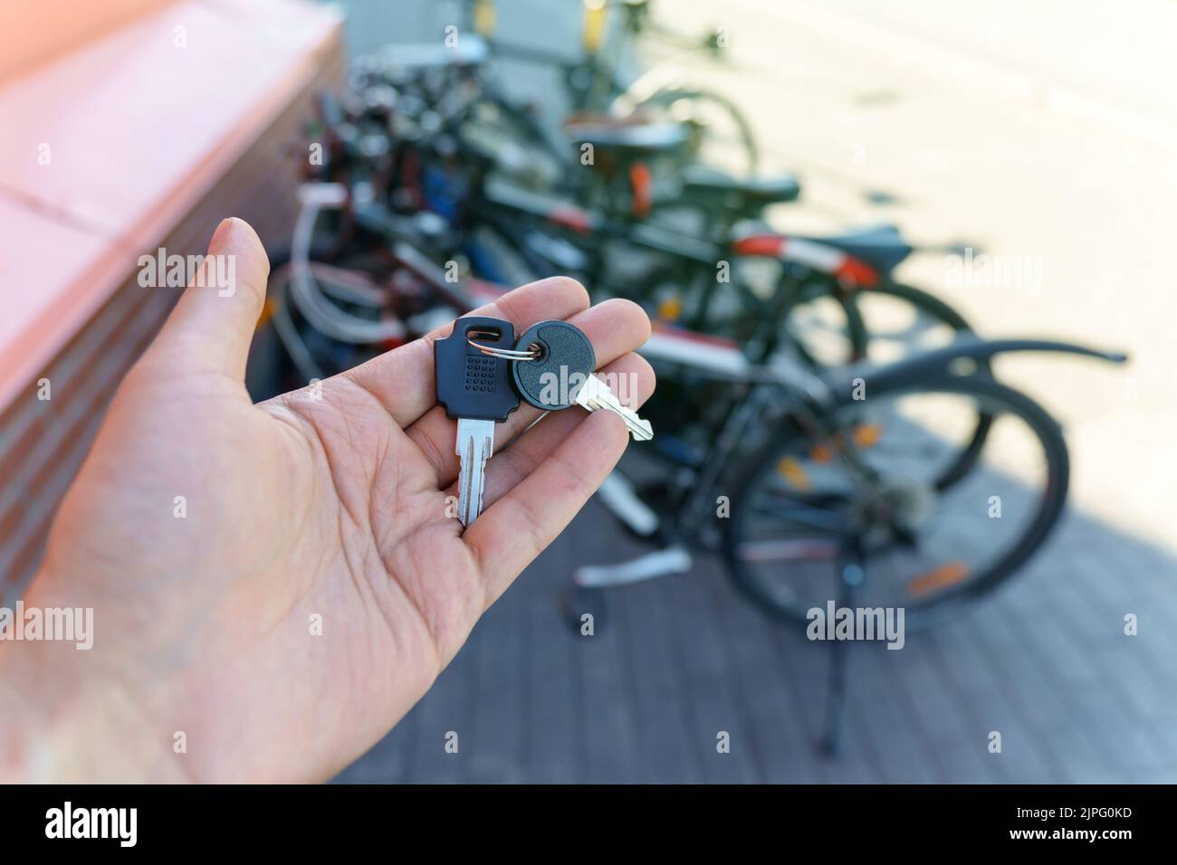 Safety concept, key lock on bicycle wheel in parking outdoor ...